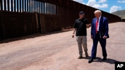 FILE - Republican presidential nominee former President Donald Trump listens to Paul Perez, president of the National Border Patrol Council, as he tours the southern border with Mexico, on Aug. 22, 2024, in Sierra Vista, Ariz. 